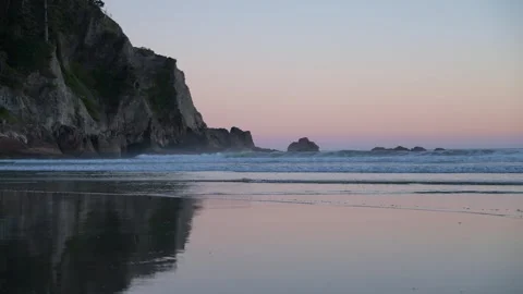 Slow Motion Waves on Beach at Sunset with Coastal Cliffs Stock Footage 341367276