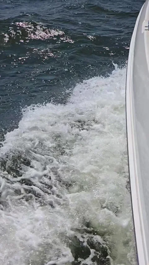 Slow motion waves with boat cutting through foam Video stock 317768137