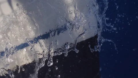 Slow motion of waves braking of sailing catamaran in summer holiday season Stock Footage 130138371