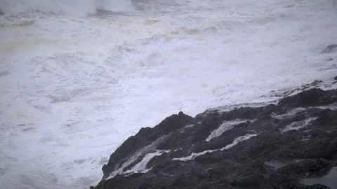 Slow-Motion Waves Breaking Against Rocks Stock Footage 88415399