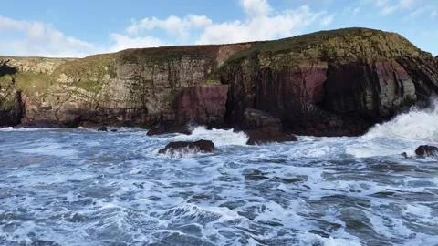 Slow Motion Waves Breaking Along Rocky Coastal Cliffs in 4K Stock-Footage 332944782