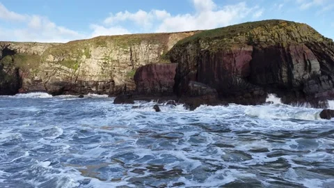 Slow Motion Waves Breaking Along Rocky Coastal Cliffs in 4K Stock-Footage 332944794
