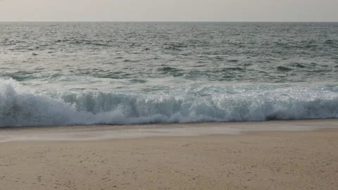 Slow motion waves breaking on beach, tracking shot Stock Footage 172485093