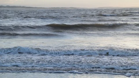 Slow motion of waves breaking, foam at wave crest. Ocean and coast at horizon Video stock 119091907