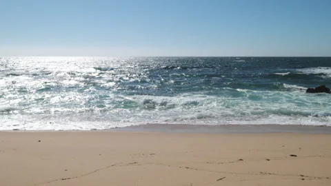Slow motion waves breaking on the golden sandy beach in summer Stock Footage 132016504