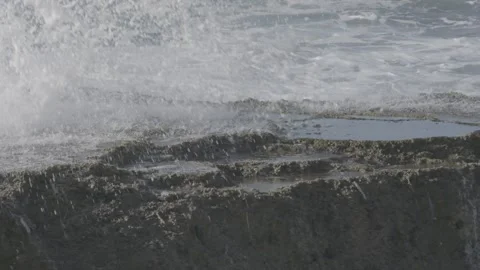 Slow motion waves breaking on rocks Stock Footage 136480937