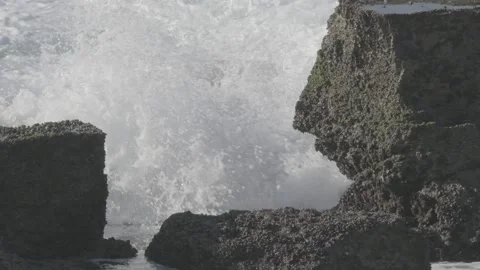 Slow motion waves breaking on rocks Stock Footage 136481418