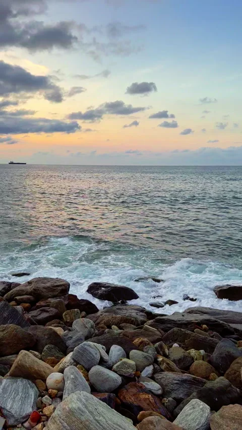 Slow motion of waves breaking on the rocks on a tropical beach at sunset. Stock Footage 286923516