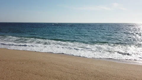 Slow motion waves breaking on sandy beach in summer. Stock Footage 192185926