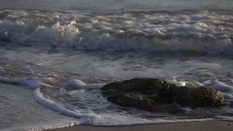 Slow Motion Waves Churning Around Rock on Beach in Israel Видео 78211590