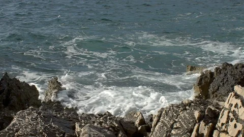 Slow motion - waves close crashing on limestone shore Stock Footage 103113050