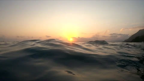 Slow Motion waves close up at sunset Stock Footage