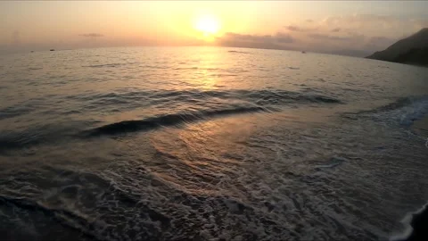 Slow Motion waves crasching on the beach at sunset Stock Footage 167925135