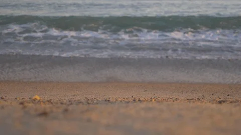 Slow Motion Waves Crash on Beach at Sunset Stockbeeldmateriaal 116688728