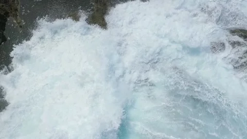 Slow motion waves crash on rugged shore and fill sinkhole in Oregon USA Stock Footage 169407026