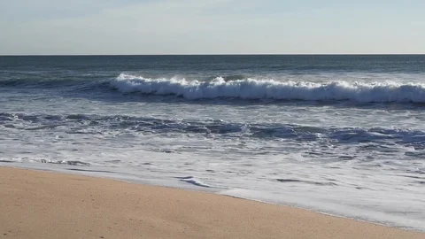 Slow motion waves crash on the sandy beach in Algarve, southern Portugal Stock Footage 102586457