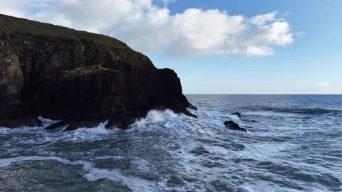 Slow Motion Waves Crashing Against Dark Rocky Coastline in 4K Vídeos de archivo 332944803