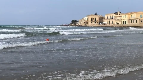 Slow motion of waves crashing on beach in Italian fisherman town Video stock 113640835