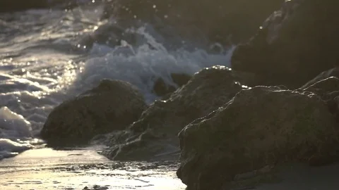 Slow Motion Waves Crashing in Golden Light from Sunset Stock Footage
