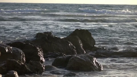 Slow Motion Waves Crashing Over Rocky Shoreline Stock Footage 78211035