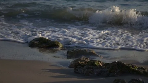 Slow Motion Waves Crashing Over Rocks on Beach Stock Footage 78211312
