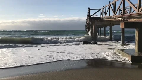 The slow motion of the waves crashing into the pillars Stock Footage 132277650