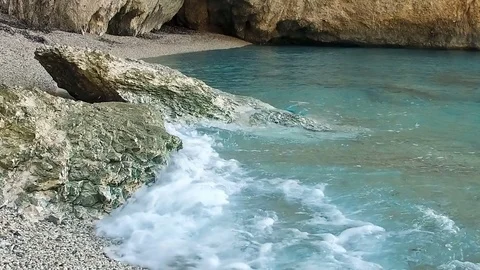 Slow motion of waves crashing on the rocks and crystal clear water, relax scene Stock Footage 80036593