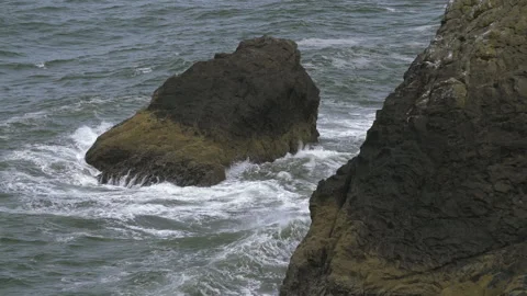 Slow Motion Waves Crashing into rocks near shore Stock Footage 165301405