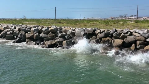 Slow motion of waves crashing into rocks in Oceanside, 4K Stock Footage 203119097