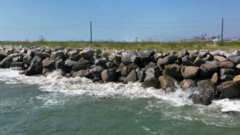 Slow motion of waves crashing into rocks Stock Footage 203119098