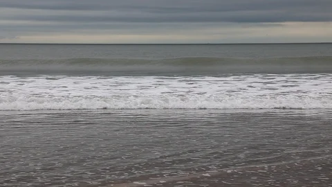 Slow motion waves crashing onto sandy beach #2 Stock Footage 88584434