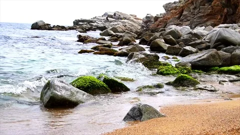 Slow motion waves crashing on shore of Costa Brava Stock Footage 195349532