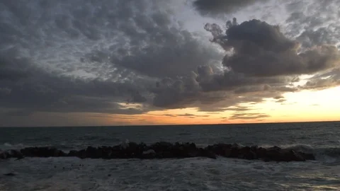 Slow motion - Waves crashing on stone jetty at gorgeous sunset Video stock 103190950