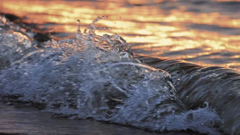 Slow Motion of Waves Crashing at Sunset Stock Footage 168326972