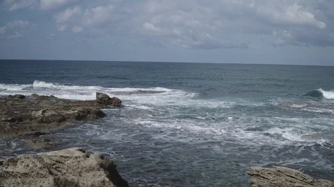 Slow motion waves craves onto ruins of Caesarea by the sea Stock Footage 86070411