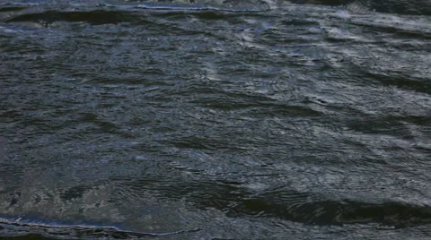 Slow motion of waves on dark water surface close up. Stock Footage 66519736