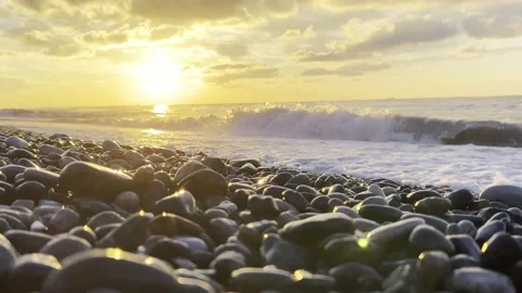 Slow motion of the waves during sunset. Many rocks on the beach coast in Batumi Stock Footage 229923019