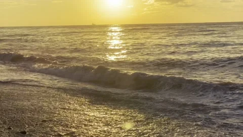 Slow motion of the waves during sunset. Many rocks on the beach coast in Batumi Stock Footage 229923034
