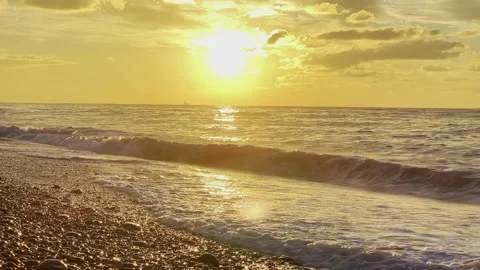 Slow motion of the waves during sunset. Many rocks on the beach coast in Batumi Stock Footage 229923089