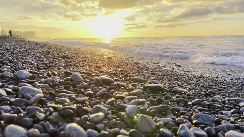 Slow motion of the waves during sunset. Many rocks on the beach coast in Batumi Stock Footage 229923134