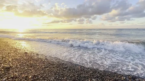 Slow motion of the waves during sunset. Many rocks on the beach coast in Batumi Stock Footage