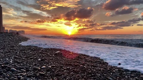 Slow motion of the waves during sunset. Many rocks on the beach coast in Batumi Stock Footage 229923381
