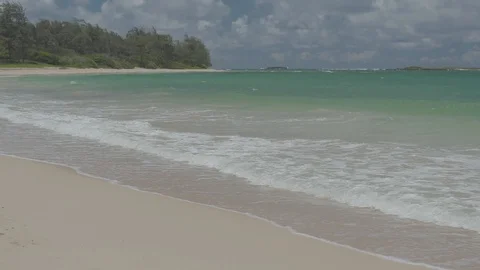 Slow Motion Waves on a Empty Sandy Beach Wide Stock Footage 100985462