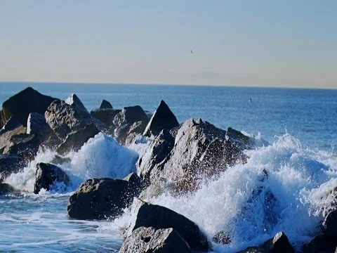  Slow motion The waves hit the rocks on the beach Stock Footage 84826404