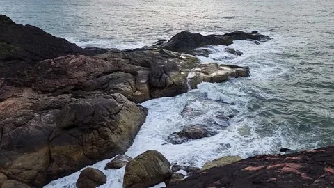 Slow-Motion Waves Hitting Rocks at Sunset Stock Footage 237172999