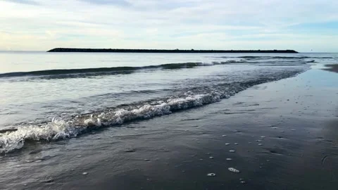 Slow motion of waves hitting the sand, The sea in the morning Stock Footage 234794985