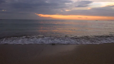 Slow motion waves land on beautiful sunset beach, Thailand Stock Footage 143878064