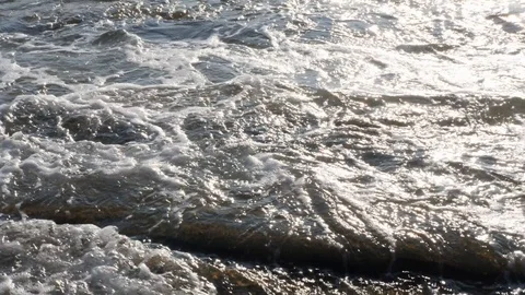 Slow motion of waves on ocean shore in the sunlight on rocky coast Stock Footage 118817998