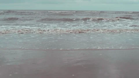 Slow motion waves over sand at the beach Stock Footage 132540787
