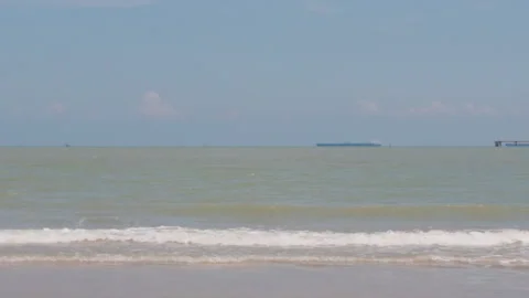 Slow Motion Waves at Pantai Puteri Beach with Distant Ship Stock Footage 346798435